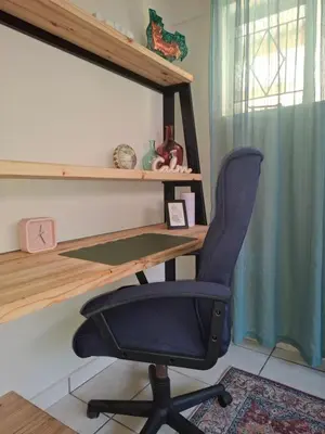 a desk and a chair in a room at Just Dandee in Naboomspruit