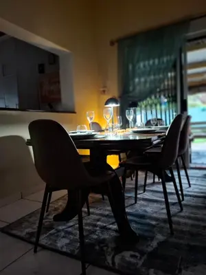 a dining room table with chairs and wine glasses at Just Dandee in Naboomspruit