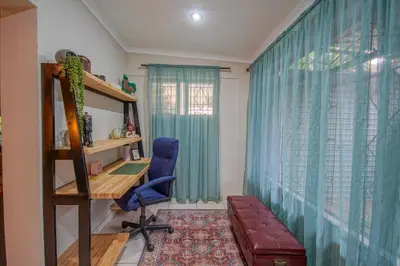 a room with a desk and a chair and a window at Just Dandee in Naboomspruit