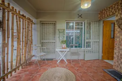 a room with a table and chairs and a window at Just Dandee in Naboomspruit