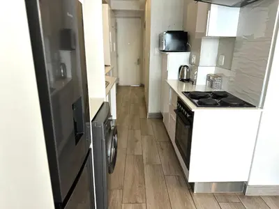 a kitchen with a stove and a counter top at Stay at Regency Luxe One in Pretoria