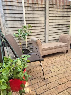 a couch and a chair on a patio at Jenkins Re-Treat in Pretoria