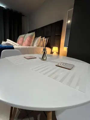 a white table in a room with a bed at The 210 Circa Pretoria Studio in Pretoria