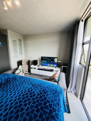 a bedroom with a bed and a flat screen tv at The 210 Circa Pretoria Studio in Pretoria