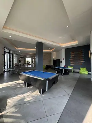 a large room with a pool table in it at Penthouse On Tropical - The Blyde in Pretoria