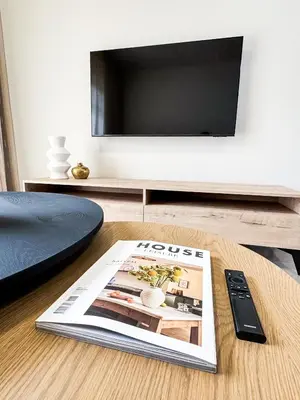 a magazine sitting on a table with a tv at Executive Apartment at Waterfall Ridge in Midrand