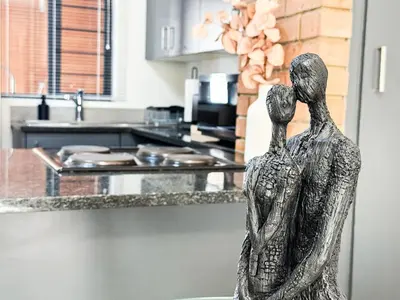 a statue of a woman standing in a kitchen at Executive Apartment at Waterfall Ridge in Midrand
