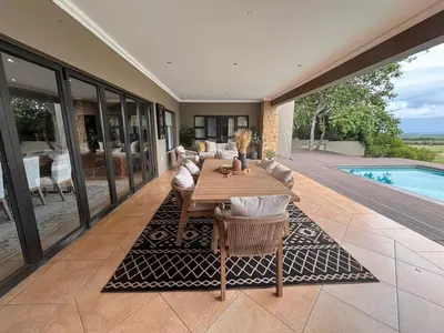 a patio with a table and chairs and a pool at Euphoria Self Catering Home in Naboomspruit