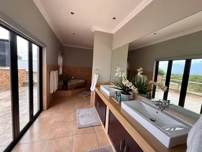 a bathroom with two sinks and a large mirror at Euphoria Self Catering Home in Naboomspruit