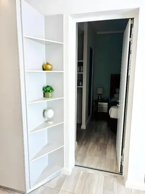 a door into a room with white shelves at Menlyn Maine Residences - Capital Trilogy in Pretoria
