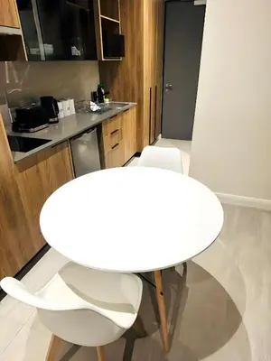 a white table and chairs in a kitchen at Menlyn Maine Residences - Capital Trilogy in Pretoria