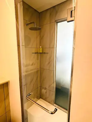 a shower with a glass door in a bathroom at Menlyn Maine Residences - Capital Trilogy in Pretoria