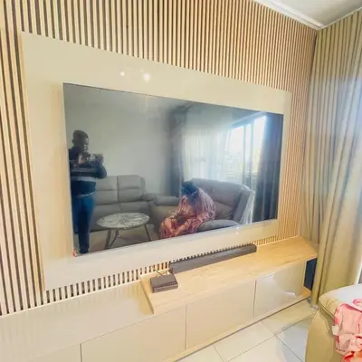 a person taking a picture in a mirror in a living room at The Blyde Crystal lagoon in Pretoria