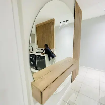 a person standing in a kitchen through a mirror at The Blyde Crystal lagoon in Pretoria