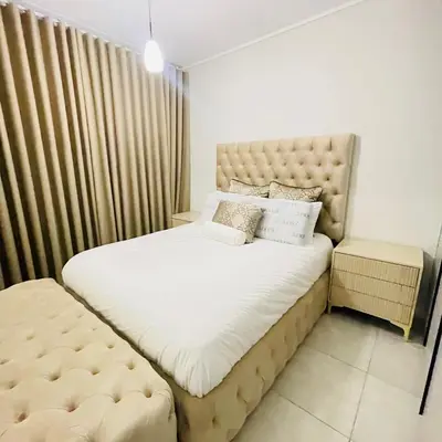 a bedroom with a large bed with a tufted headboard at The Blyde Crystal lagoon in Pretoria