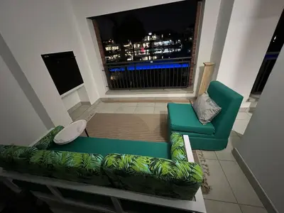 a living room with a green couch and a window at The Blyde Crystal lagoon in Pretoria