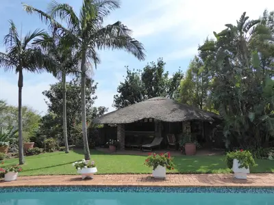 a resort with a gazebo and palm trees at Viva-Africa in Pretoria