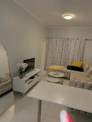 a living room with a couch and a table at Charlsi luxury in Midrand
