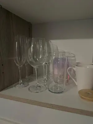 a row of wine glasses sitting on a shelf at Charlsi luxury in Midrand