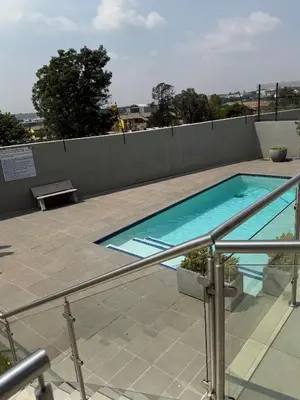 a swimming pool on top of a building at Charlsi luxury in Midrand