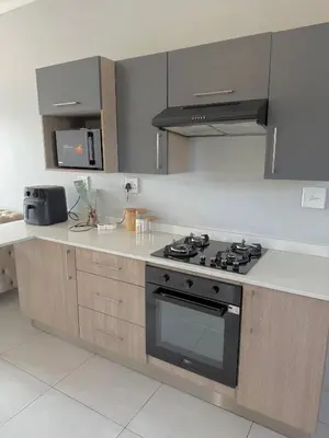 a kitchen with a stove and a counter top at Charlsi luxury in Midrand