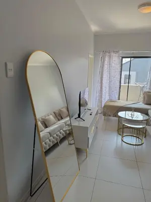 a living room with a mirror and a couch at Charlsi luxury in Midrand