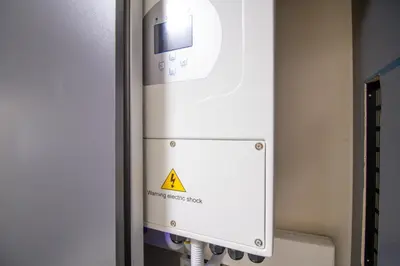 a machine with a warning sign in a room at Waterfall Ridge Luxurious Apartments - Backup Power! in Midrand
