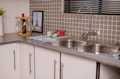 a kitchen counter with a stainless steel sink at SinoVilla397 in Pretoria