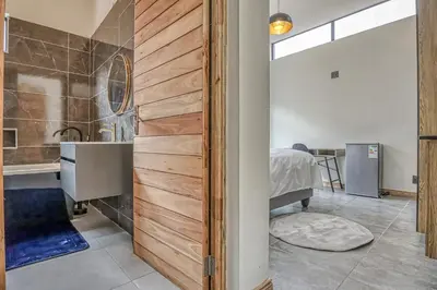 a bathroom with a sink and a shower in a room at The Waterkloof Gables in Pretoria
