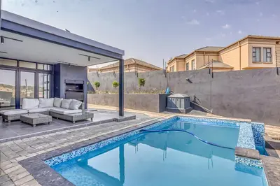 a swimming pool in the backyard of a house at The Waterkloof Gables in Pretoria