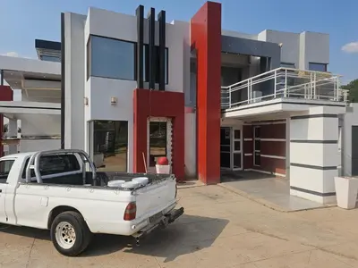 a white truck parked in front of a building at TURFLOOP guest house in Mankweng