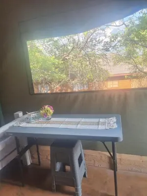 a blue table in a room with a window at Pumba's Den Kranspoort in Winterkamp
