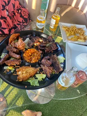 a plate of food on a glass table with food at Makhasana
