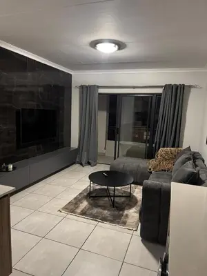 a living room with a couch and a table at The Dream Stay At The Blyde - Suite 3 in Pretoria