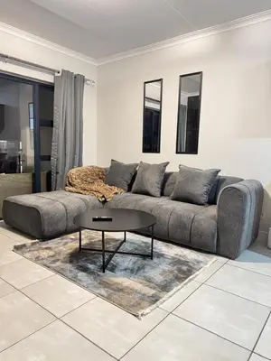 a living room with a couch and a table at The Dream Stay At The Blyde - Suite 3 in Pretoria