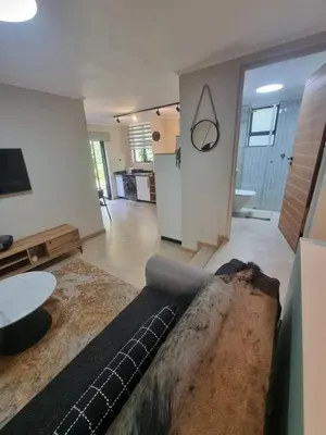 a living room with a couch and a table at Edward suites ,Apartment 2 in Pretoria