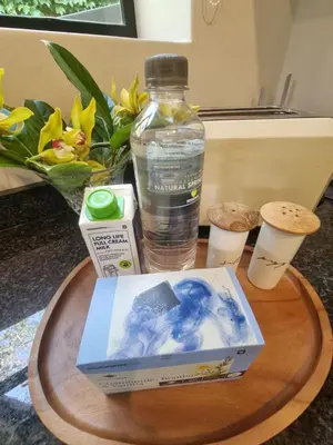 a bottle of water and a book on a table at Edward suites ,Apartment 2 in Pretoria