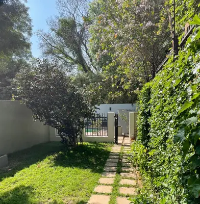 a garden with a gate and a fence at Edward suites ,Apartment 2 in Pretoria