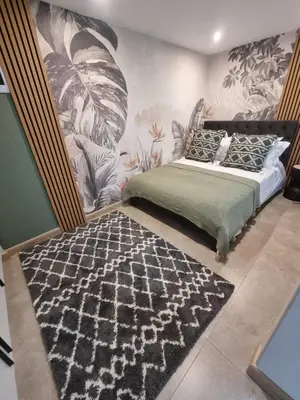 a bedroom with a bed and a wall mural at Edward suites ,Apartment 2 in Pretoria