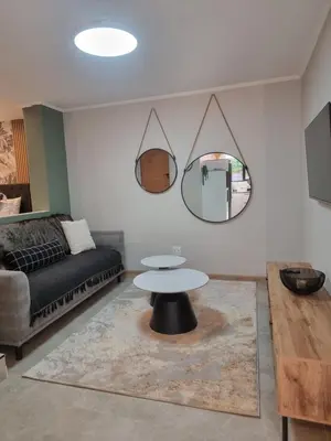 a living room with a table and a couch at Edward suites ,Apartment 2 in Pretoria