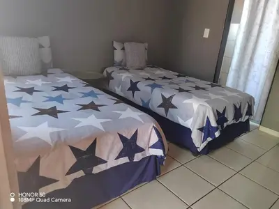 two beds sitting next to each other in a room at Dula Bonolo Lodge in Lebaleng
