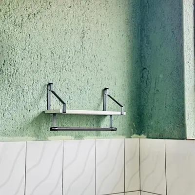 a green wall with a shelf on a bathroom at Dula Bonolo Lodge in Lebaleng