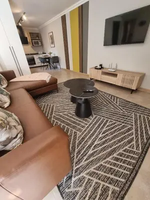 a living room with a couch and a table at Edward Suites, Apartment 1 in Pretoria