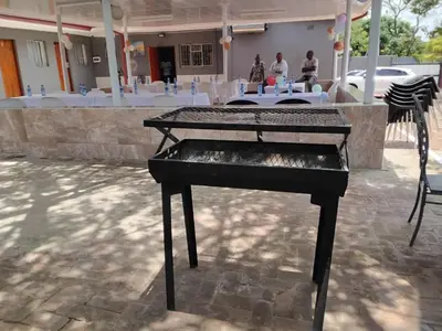 a black piano sitting in front of a table at Best Enough Guesthouse in Pretoria