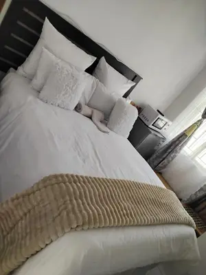 a large bed with a baby laying on it at Best Enough Guesthouse in Pretoria