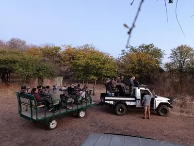 a group of people are riding on a truck at Lapa Moyo Safari's in Linton