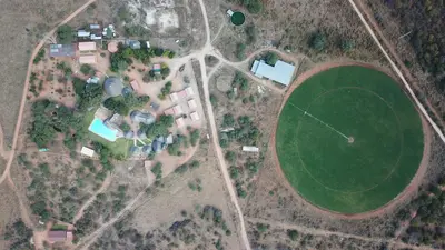 an overhead view of a field with houses and a green field at Lapa Moyo Safari's in Linton