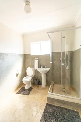 a bathroom with a shower and a toilet and a sink at 28 Schalk drive in Polokwane
