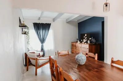 a dining room with a wooden table and chairs at 28 Schalk drive in Polokwane