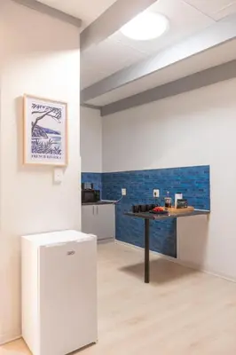 a kitchen with a table in a room with blue tiles at 28 Schalk drive in Polokwane